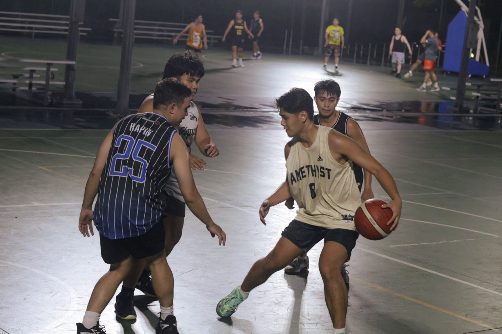 Players battling for the ball at the BTC Parqal Run, a pickup basketball run in Manila