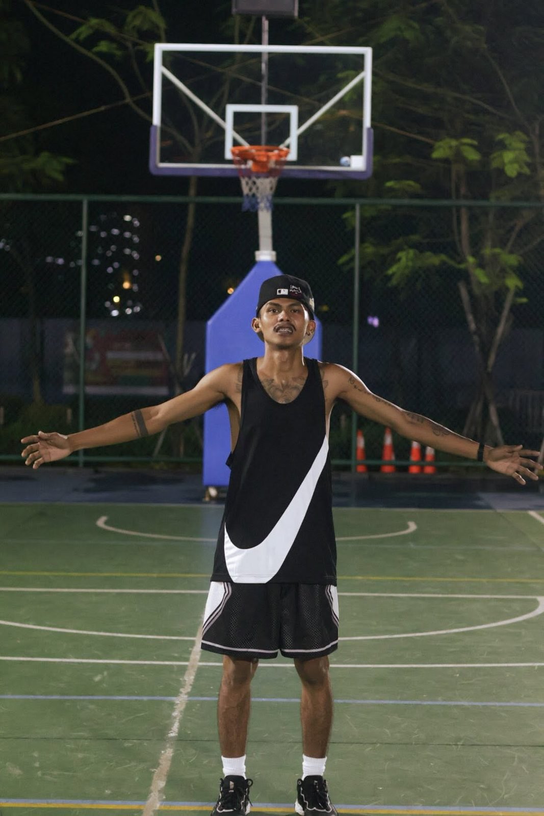 Player posing under the ring at a BTC basketball run
